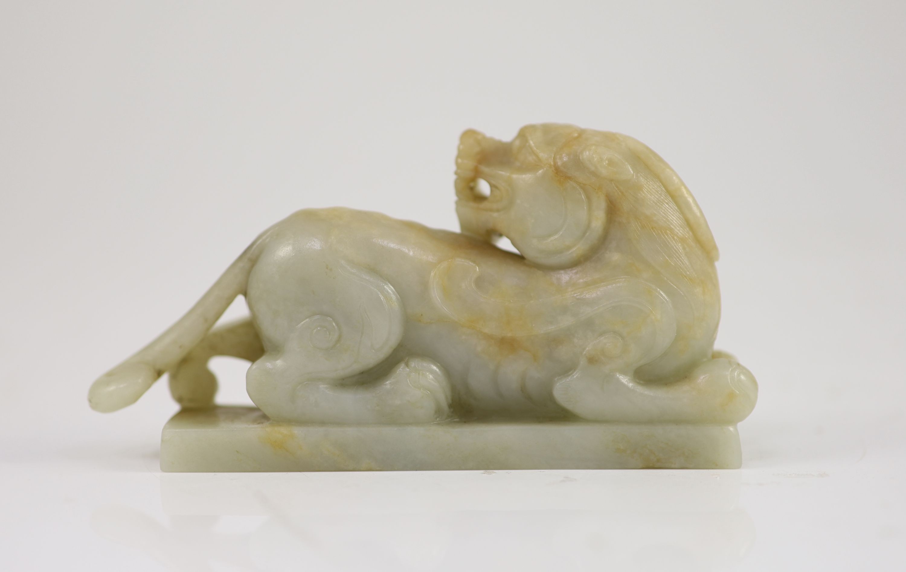 A Chinese Ming archaistic pale celadon and russet jade figure of a pixiu, 16th/17th century, 11.5cm long